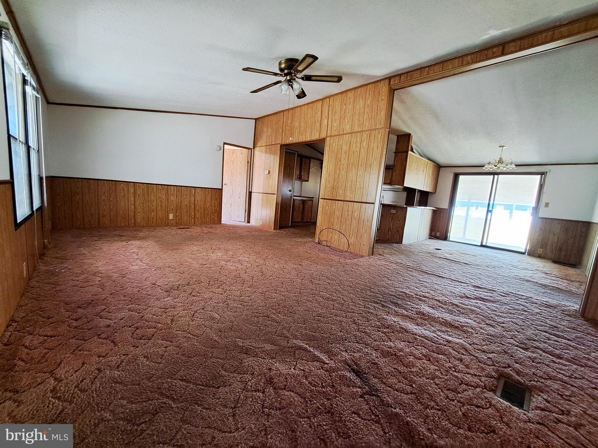 6706 Whiteley Road Hurlock, MD 21643 - Photo 9 of 45 a view of empty room with wooden floor and fan