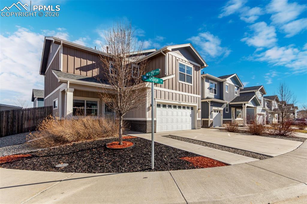 Craftsman inspired home with board and batten siding, concrete driveway, and a garage