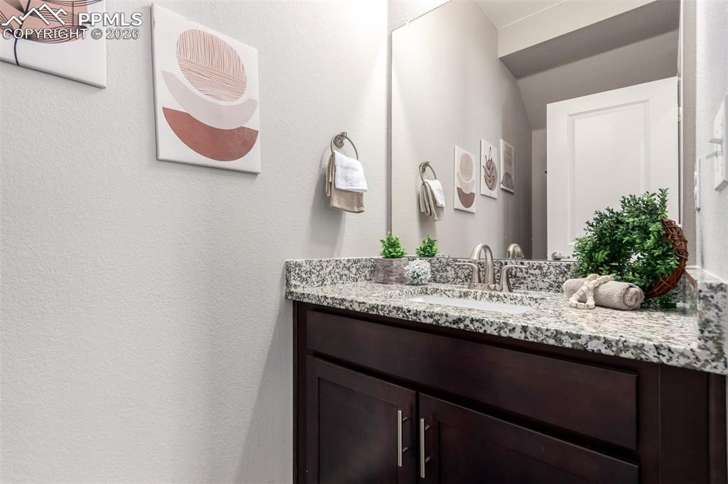 7956 Osage Street Denver, CO 80221 - Photo 15 of 48 Bathroom featuring vanity and a textured wall