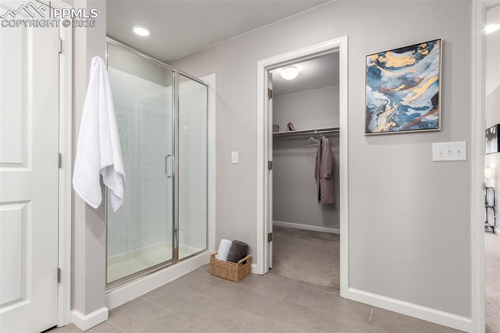 7956 Osage Street Denver, CO 80221 - Photo 21 of 48 Bathroom with a shower stall, a walk in closet, recessed lighting, and light tile patterned flooring