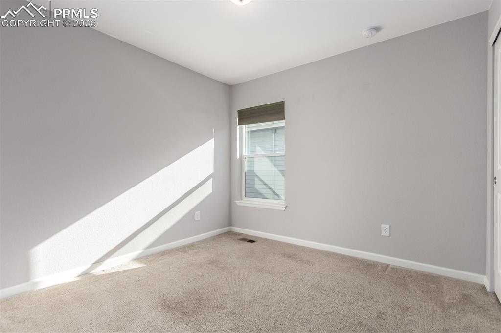 7956 Osage Street Denver, CO 80221 - Photo 27 of 48 Empty room with baseboards and light carpet