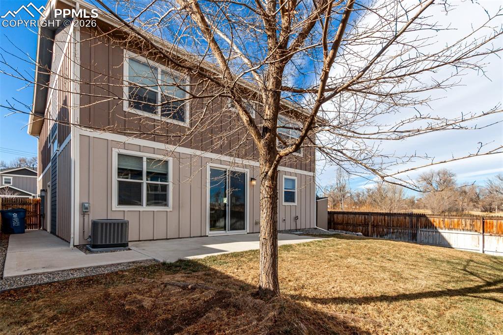 7956 Osage Street Denver, CO 80221 - Photo 33 of 48 Back of house with a fenced backyard, a patio area, and board and batten siding