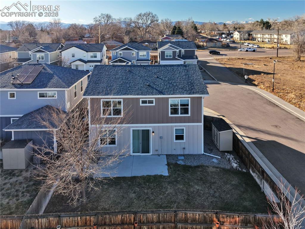 7956 Osage Street Denver, CO 80221 - Photo 45 of 48 Back of property with a residential view, a patio, and a fenced backyard