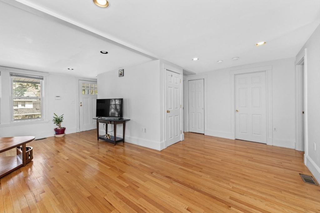 15 Murray Hill Road Medford, MA 02155 - Photo 13 of 30 a view of an empty room with window and a wooden floor