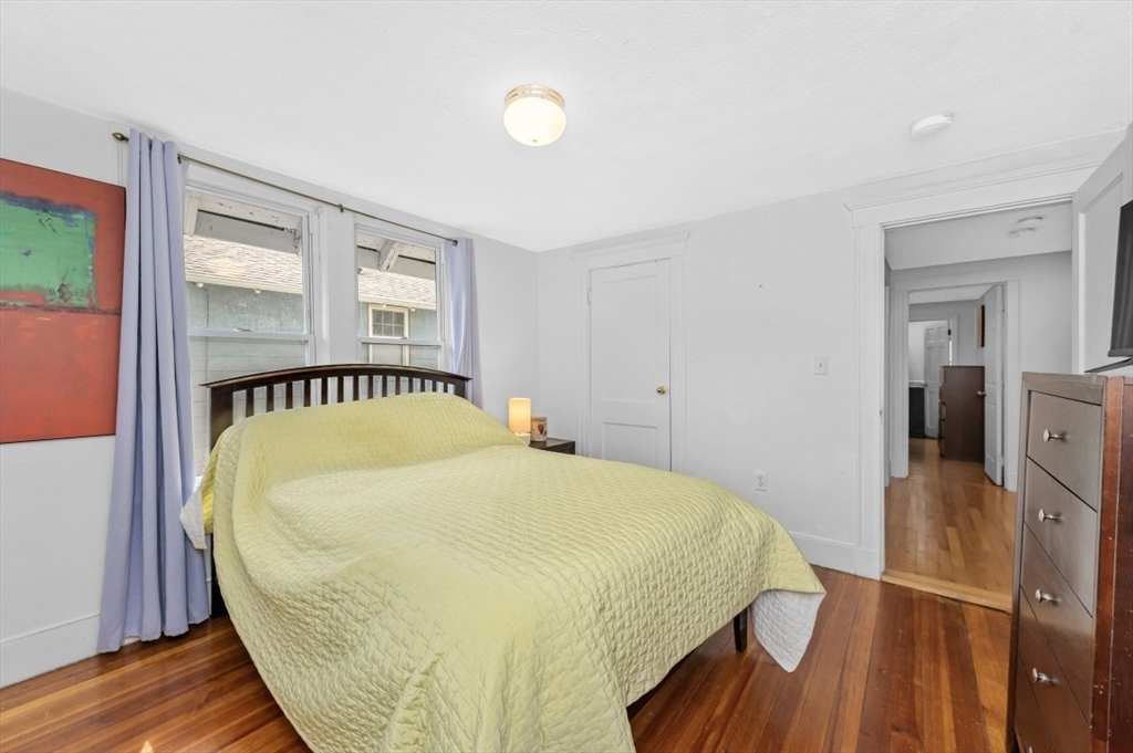 15 Murray Hill Road Medford, MA 02155 - Photo 17 of 30 a bedroom with a bed and wooden floor