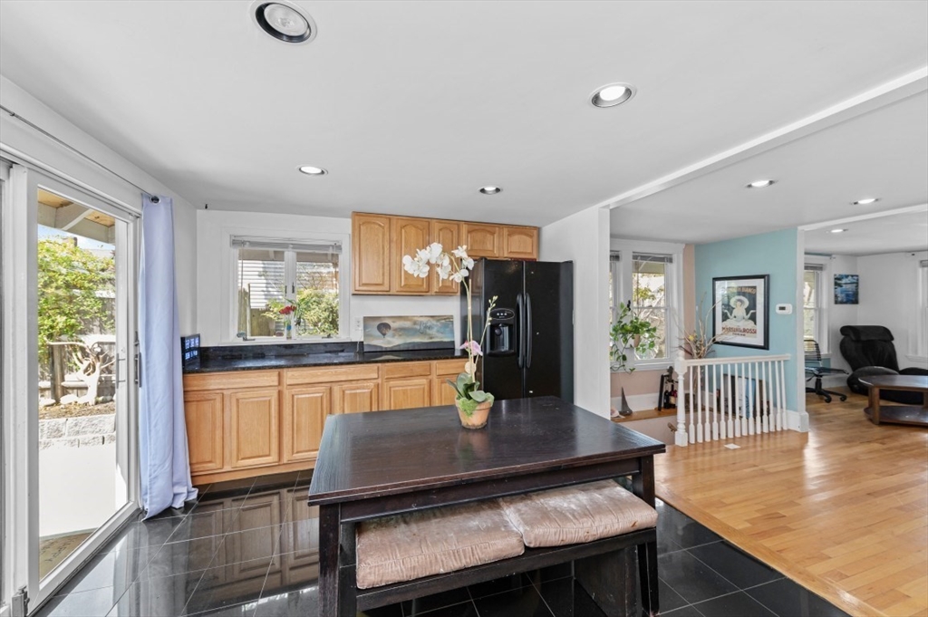 15 Murray Hill Road Medford, MA 02155 - Photo 8 of 30 a kitchen with stainless steel appliances granite countertop a table chairs and a refrigerator