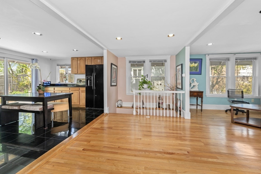 15 Murray Hill Road Medford, MA 02155 - Photo 10 of 30 a open kitchen with stainless steel appliances granite countertop a refrigerator a stove a dining table and chairs with wooden floor