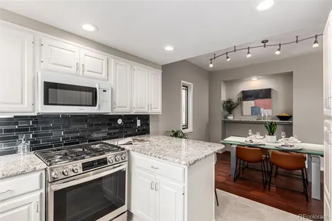 a kitchen with a stove a sink and a microwave