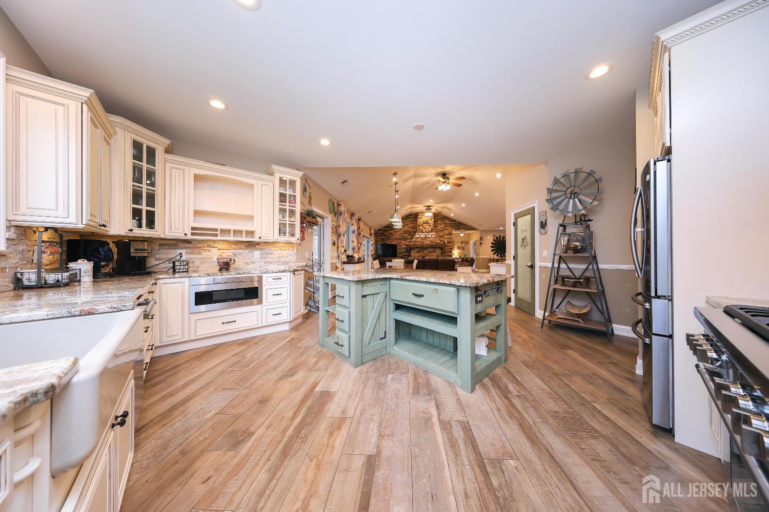 94 East Pleasant Grove Road Jackson, NJ 08527 - Photo 24 of 59 a kitchen view with stainless steel appliances wooden floor and a view of living room