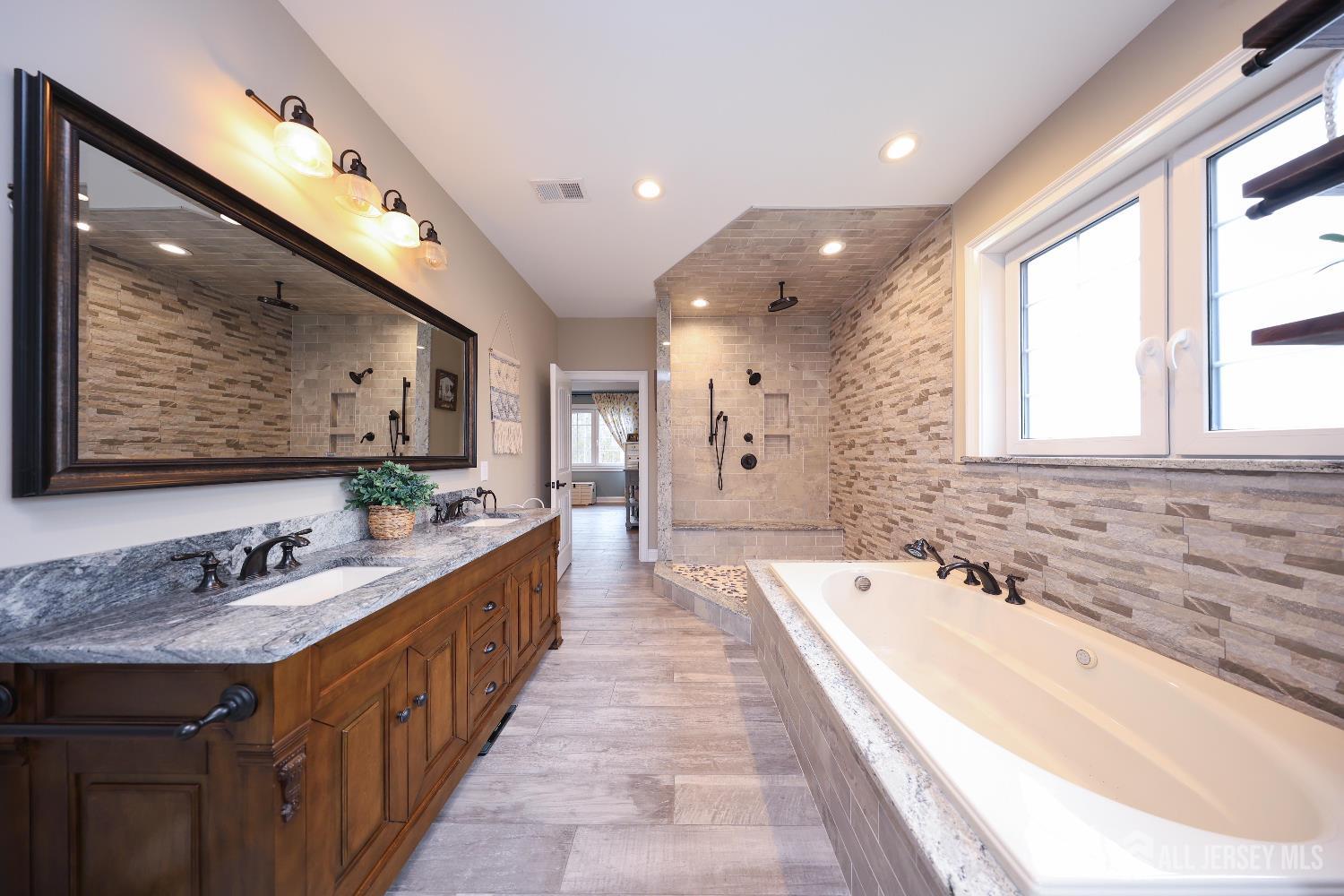 94 East Pleasant Grove Road Jackson, NJ 08527 - Photo 32 of 59 a spacious bathroom with sinks mirror and a bathtub