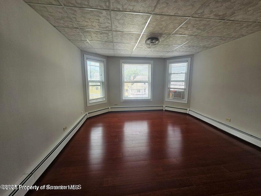 16 Swallow Street, Unit 1 Pittston, PA 18640 - Photo 4 of 14 an empty room with wooden floor and windows