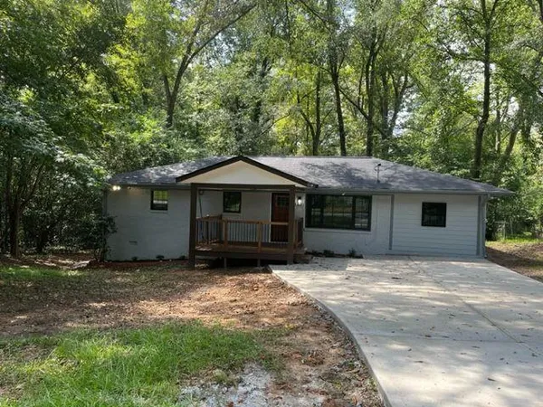 a house with trees in the background