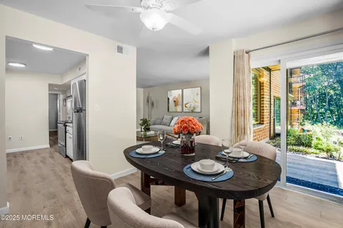 a view of a dining room with furniture and wooden floor