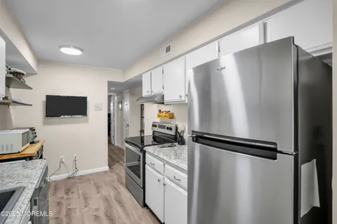 a kitchen with stainless steel appliances a refrigerator and a stove top oven
