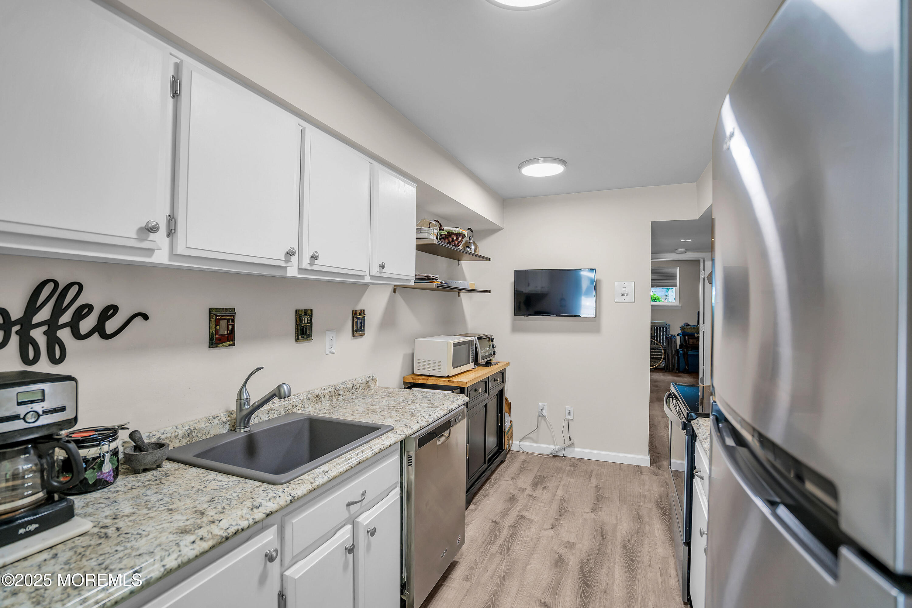 200 Portland Road, Unit E4 Highlands, NJ 07732 - Photo 16 of 37 a kitchen with stainless steel appliances granite countertop a sink stove and refrigerator