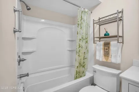 a bathroom with a shower a mirror and a shower