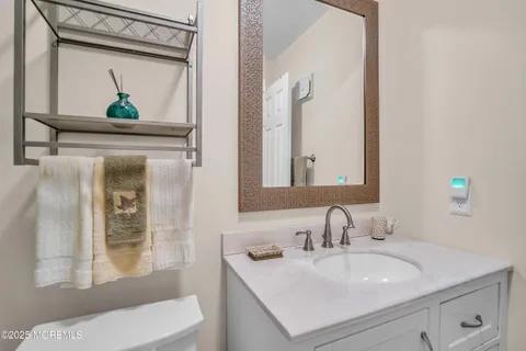 a bathroom with a toilet a sink and mirror