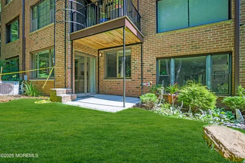 a view of a house with a yard and sitting area