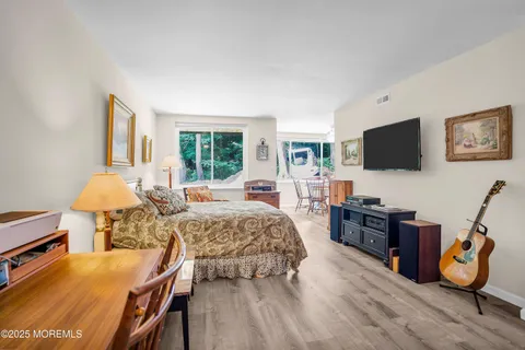a bedroom with furniture and a flat screen tv