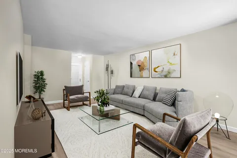 a living room with furniture rug and wooden floor