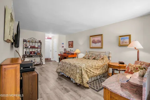 a bedroom with a bed furniture and a flat screen tv