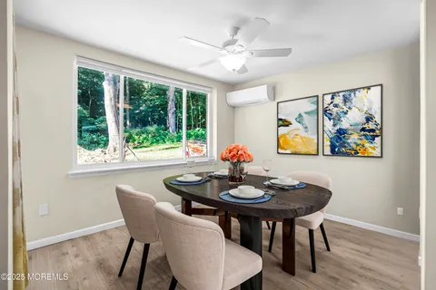 a view of a dining room with furniture window and wooden floor