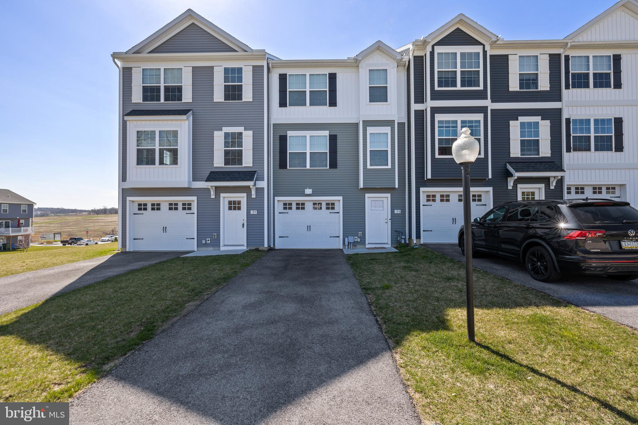 a view of a parked cars in front of a brick house