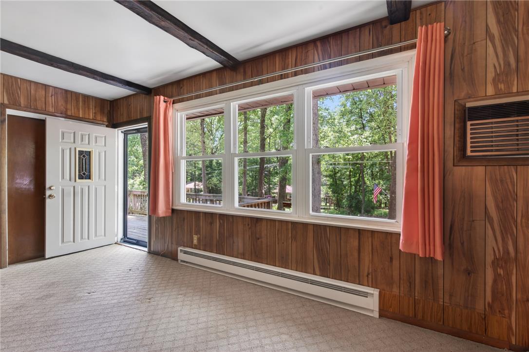 18 White Oak Road Nesquehoning, PA 18240 - Photo 14 of 52 A welcoming entry space with wood-paneled walls and exposed ceiling beams offers serene tree-lined views.