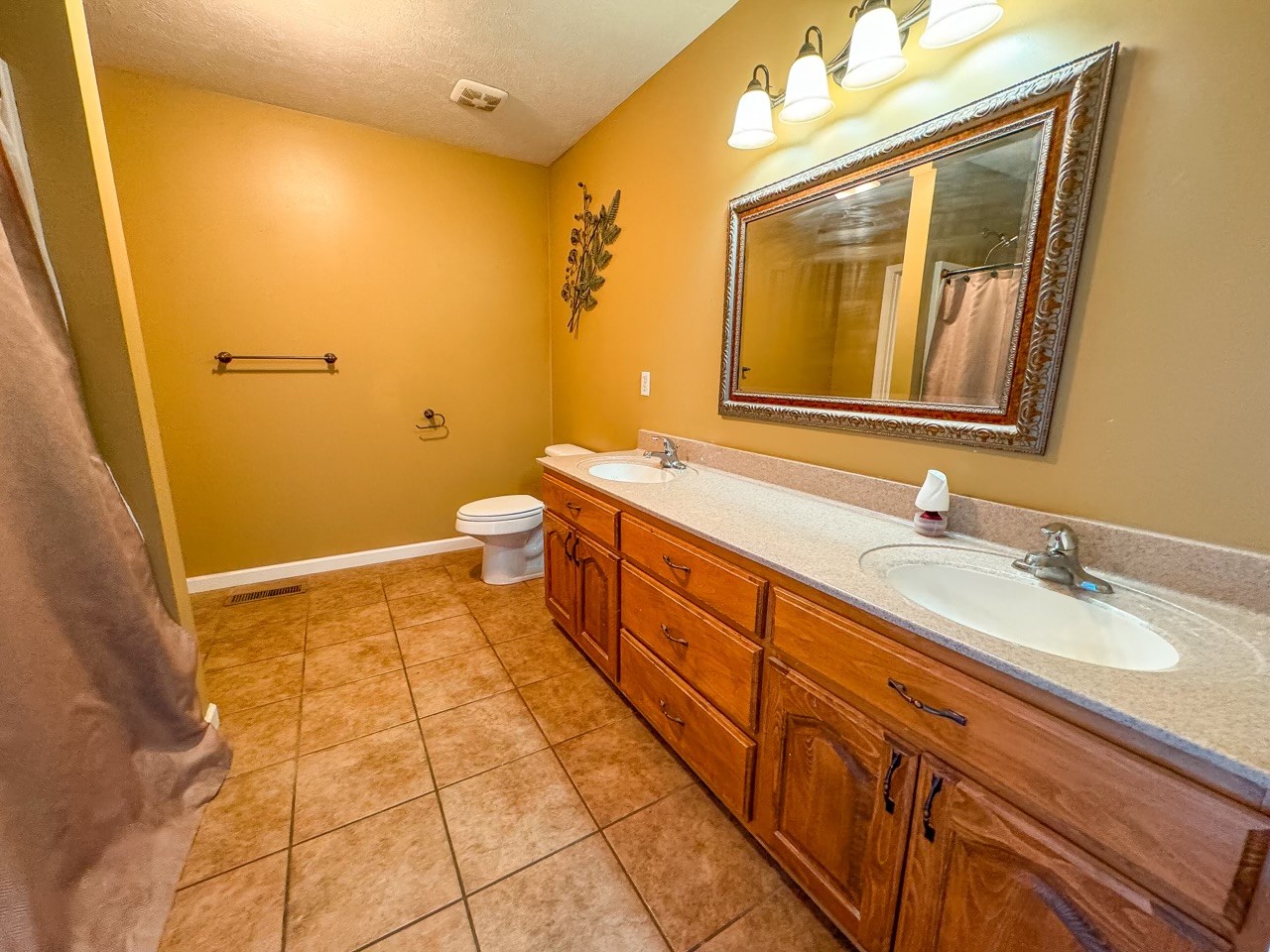 35 Whitaker Bend Road Linden, TN 37096 - Photo 11 of 36 a spacious bathroom with a granite countertop sink mirror and a toilet