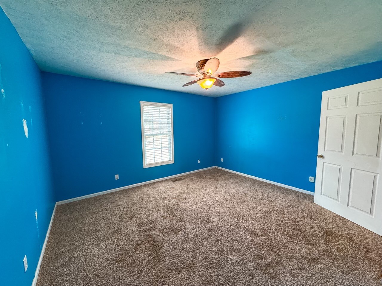 35 Whitaker Bend Road Linden, TN 37096 - Photo 23 of 36 an empty room with a chandelier fan and windows