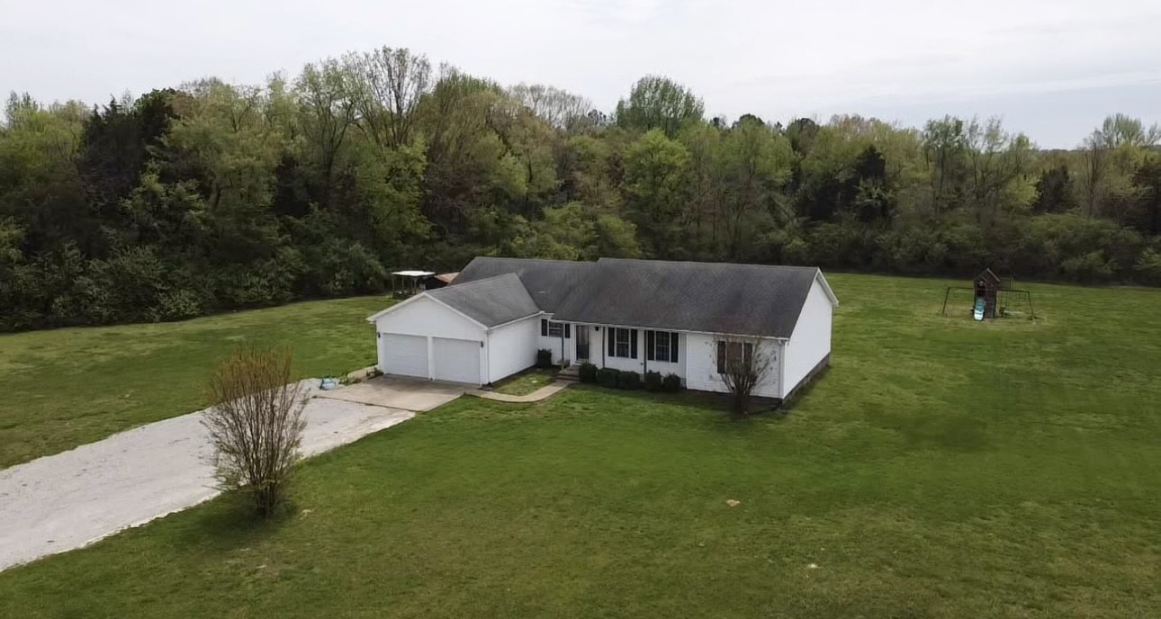 35 Whitaker Bend Road Linden, TN 37096 - Photo 34 of 36 a aerial view of a house with pool and a yard