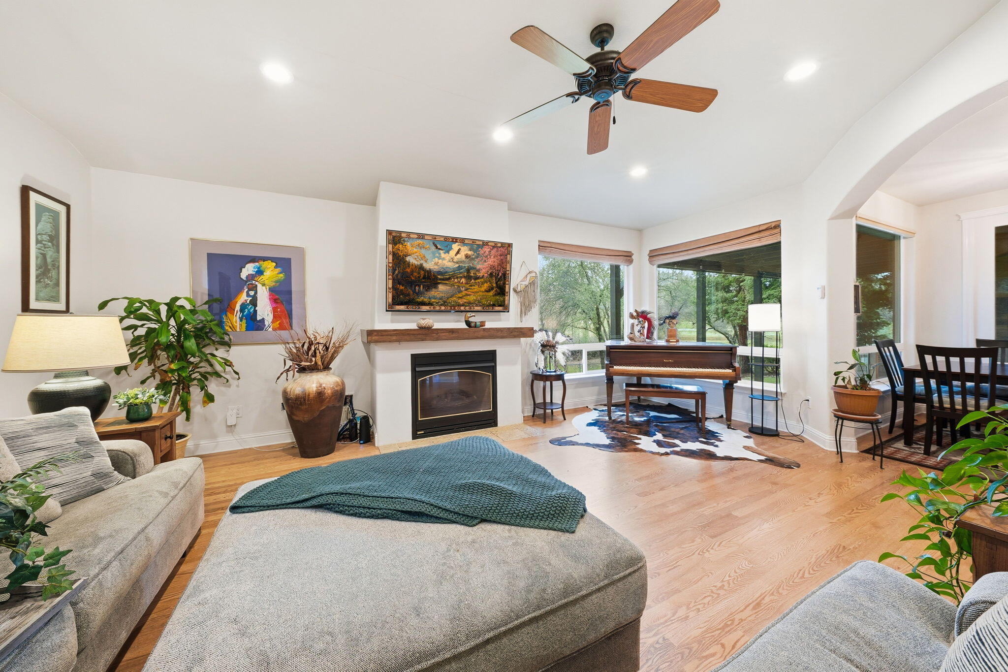 13482 Tierra Heights Road Redding, CA 96003 - Photo 14 of 41 a living room with furniture a fireplace and a flat screen tv