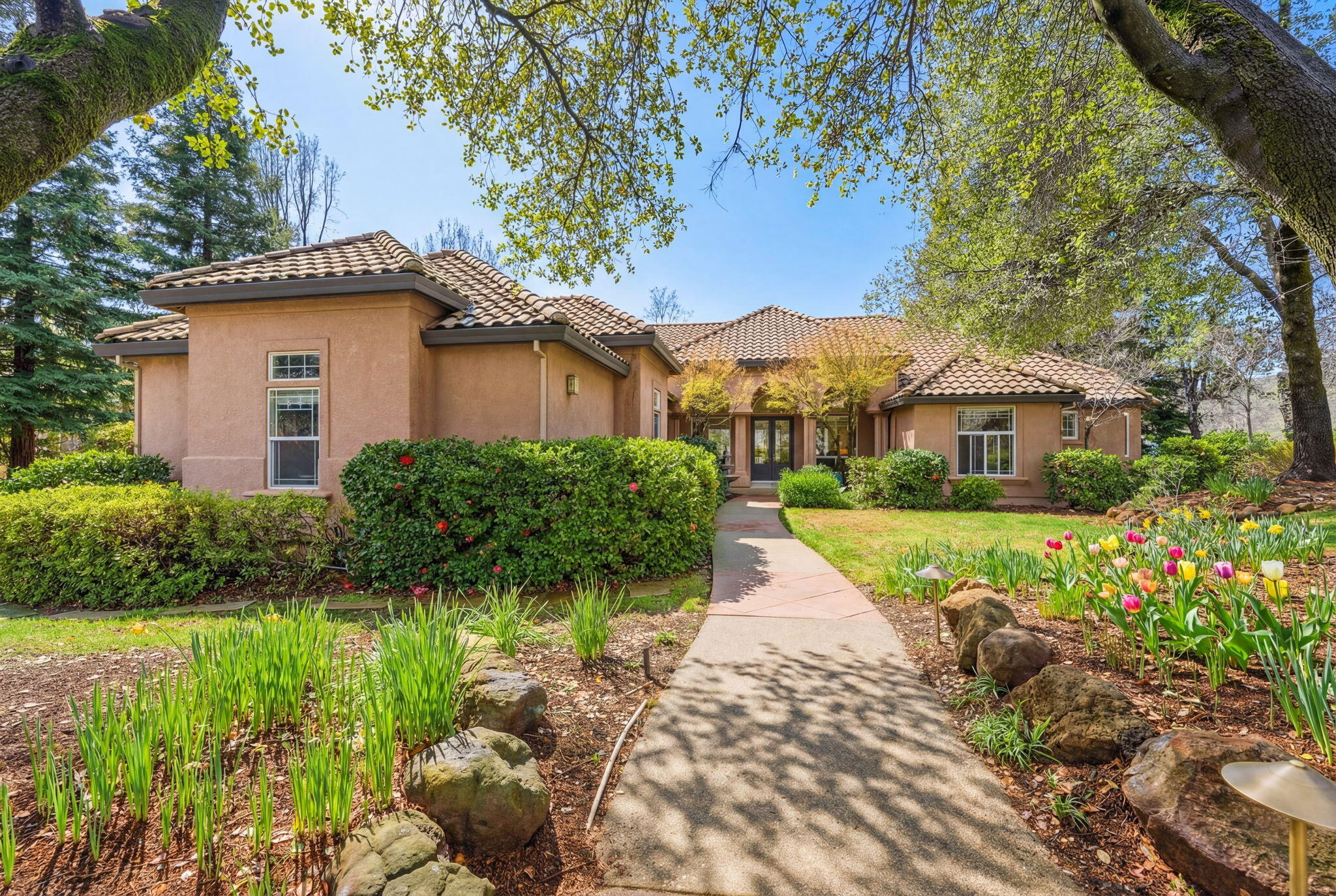 13482 Tierra Heights Road Redding, CA 96003 - Photo 2 of 41 a front view of a house with a yard and potted plants