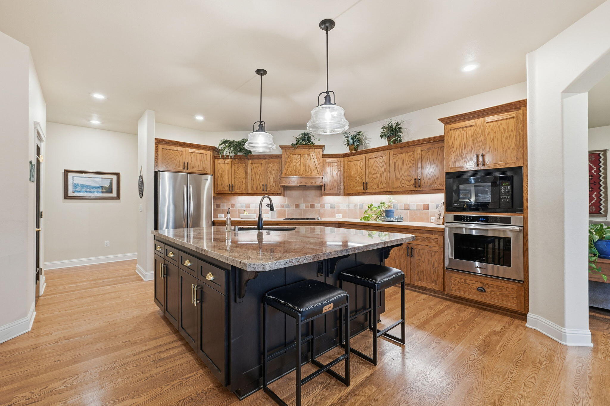 13482 Tierra Heights Road Redding, CA 96003 - Photo 10 of 41 a kitchen with stainless steel appliances granite countertop a stove a refrigerator a sink and a wooden floor