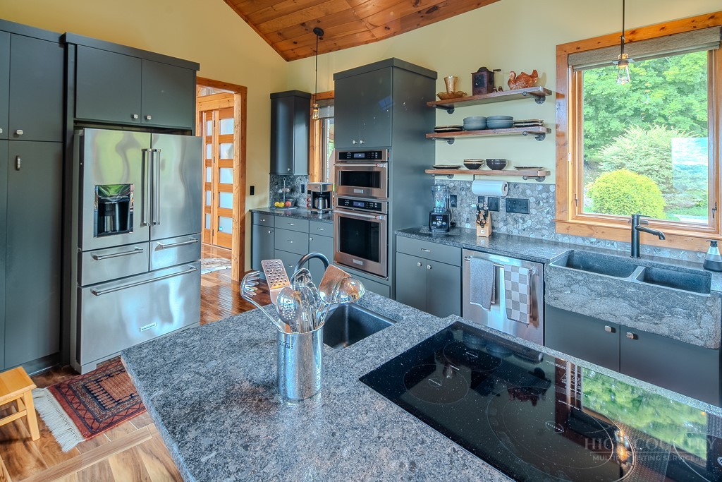 179 Adams Road Vilas, NC 28692 - Photo 10 of 50 a kitchen with stainless steel appliances granite countertop a sink and a refrigerator