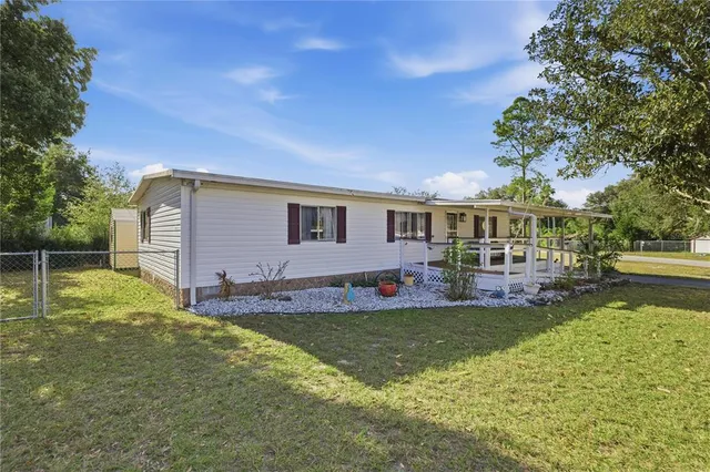 a view of a house with a yard porch and sitting area