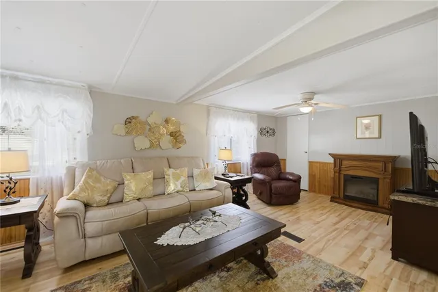 a living room with furniture fireplace and a flat screen tv