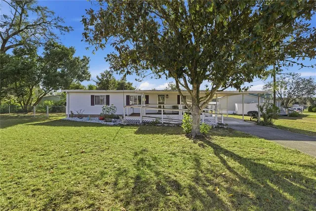 a view of house with outdoor space and garden