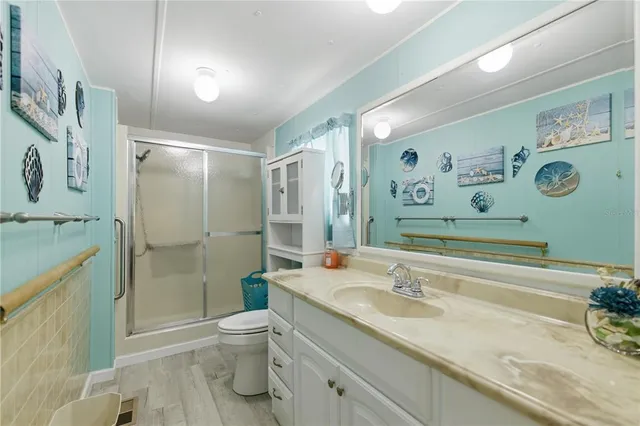 a bathroom with a granite countertop sink toilet and shower