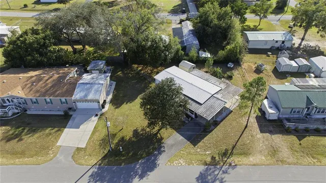 an aerial view of a house with a garden and swimming pool