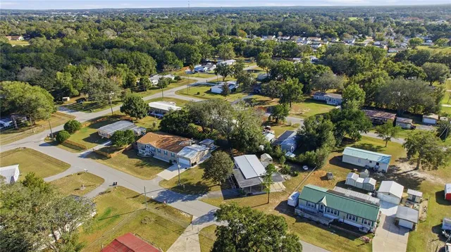 an aerial view of residential houses with outdoor space
