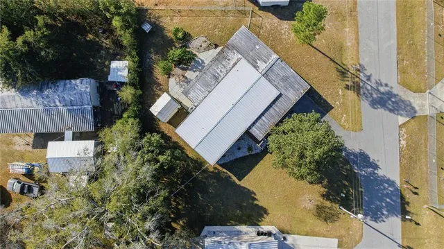an aerial view of a house with a yard