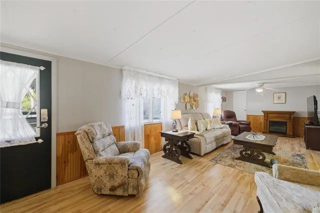 a living room with furniture window and a wooden floor