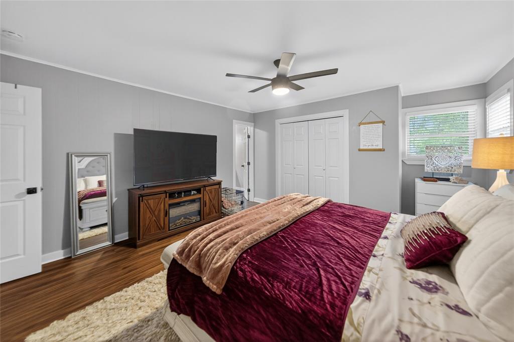 614 Colonial Drive Athens, TX 75751 - Photo 16 of 26 a bedroom with a bed and a flat screen tv