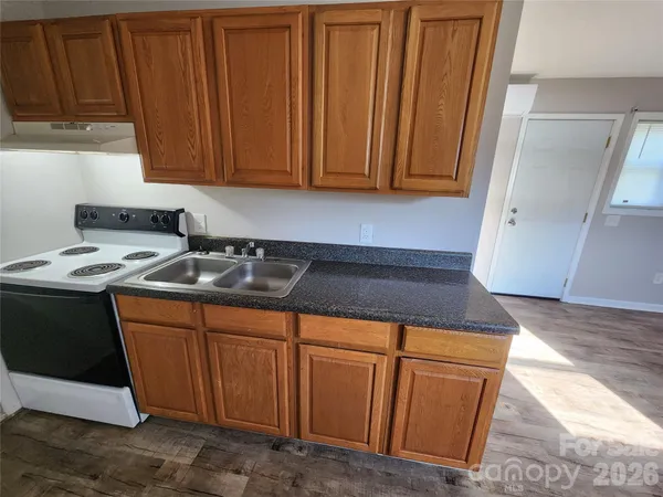 a kitchen with granite countertop cabinets and sink