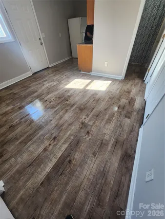 a view of a room with wooden floor
