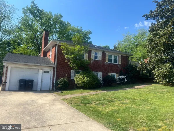 a view of a house with a yard and potted plants