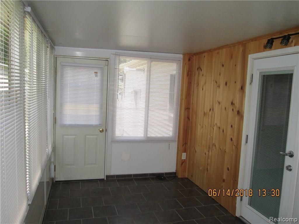 2077 Covert Road Burton, MI 48509 - Photo 20 of 34 WALLS COVERED WITH PINE FOR BEAUTY AND WARMTH/ FRENCH DOORS OPENS TO DINING AREA