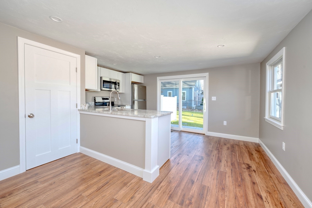 665 State Road, Unit 1 Plymouth, MA 02360 - Photo 7 of 13 a view of a kitchen with wooden floor and electronic appliances