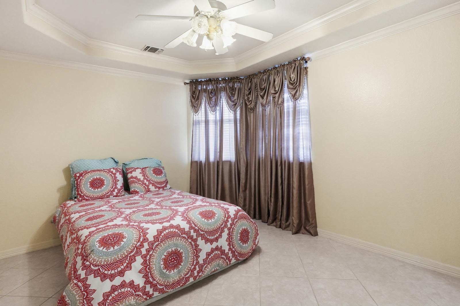 247 Old Spring Lane Houston, TX 77015 - Photo 15 of 25 a bedroom with a bed and a chandelier